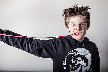 boy stretching gum from mouth thumbnail