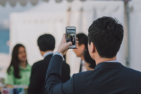 man taking picture of people taking during daytime\ thumbnail