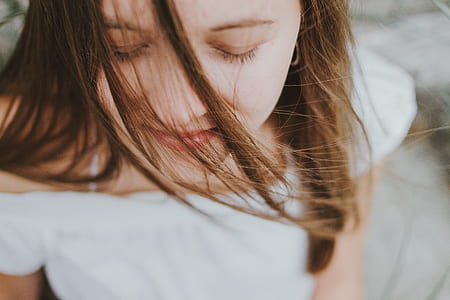 woman in white open-should dress closing eyes thumbnail