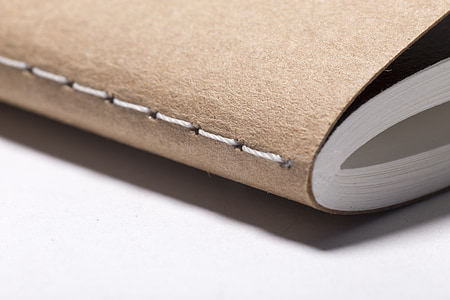 closeup photo of brown softbound book thumbnail