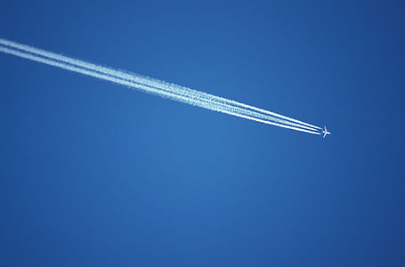 photo of plane under clear blue sky thumbnail