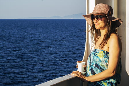 woman holding white cup thumbnail