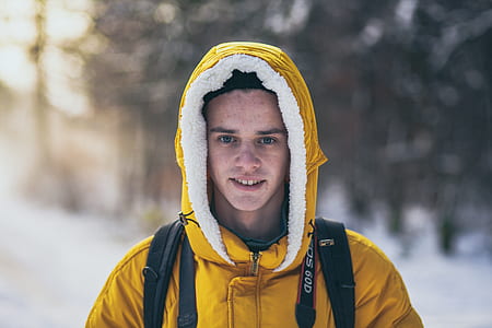 man wearing hoodie surrounded by snow thumbnail