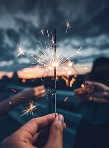 photo of person holding firecracker stick thumbnail