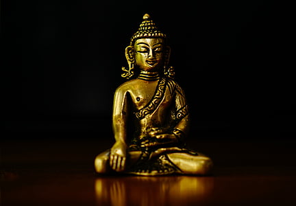 Bhumisparsha Mudra figurine on brown surface thumbnail
