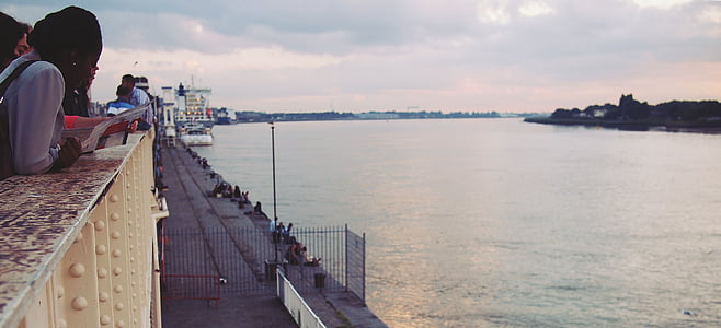 woman facing body of water thumbnail