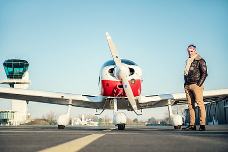 man standing beside monoplane thumbnail