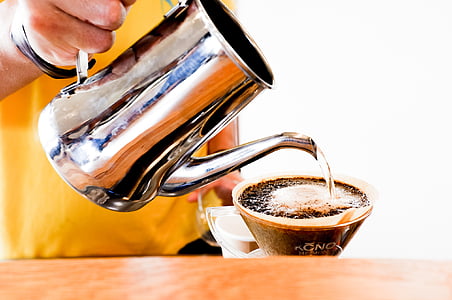 person pouring water on glass coffee cup thumbnail
