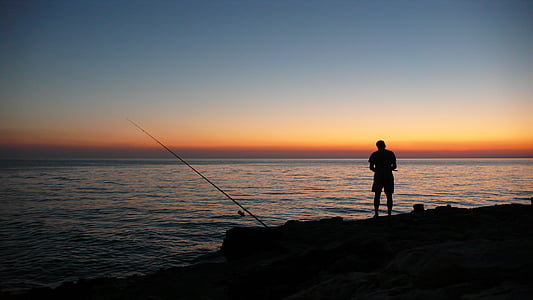 silhouette of a man near body of water thumbnail