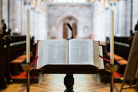 bible on stand near candlesticks thumbnail