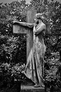 woman leaning on cross statue thumbnail