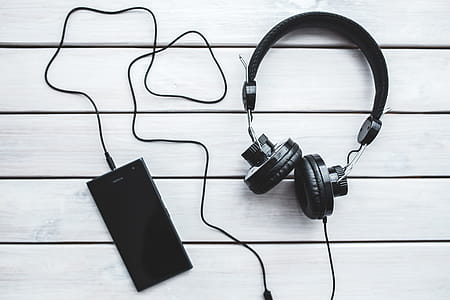 Black smartphone and headphones with various items thumbnail