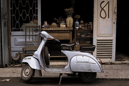 gray and black scooter beside store thumbnail