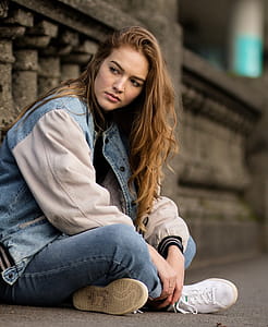 Brown Haired Woman Sitting Beside Gray Concrete Railings thumbnail