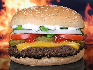 hamburger with cheese tomatoes onions and sesame seed buns thumbnail