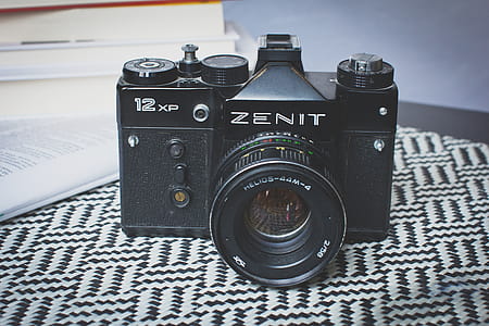 Black Zenit Dslr Camera on Top of Table thumbnail