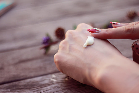 person putting lotion on arm knuckl thumbnail