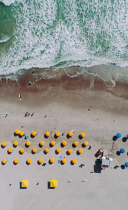 yellow patio umbrellas on seashore thumbnail
