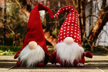 two red-and-white gnome plush toys on gray surface thumbnail
