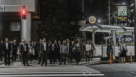 group of people walking on pedestrian lane at nighttime thumbnail