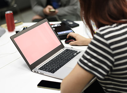 woman wearing black and white t-shirt in front of MacBook Pro thumbnail