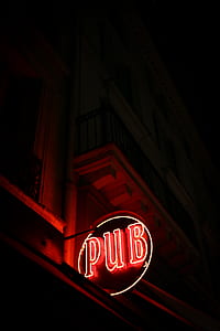 lighted red and beige pub neon sign on building thumbnail