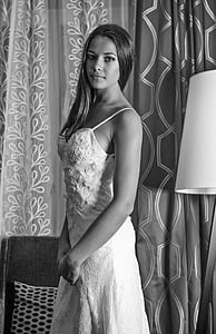 black and white photo of woman in spaghetti strap floral dress thumbnail