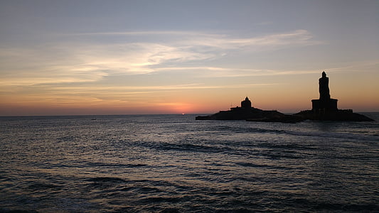 lighthouse beside body of water under calm sky thumbnail