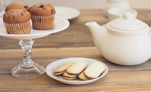 three chocolate cupcakes on white desert stand thumbnail