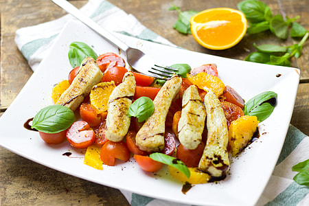 sliced tomatoes with mint served on white plate thumbnail
