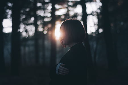 woman standing near trees during daytime thumbnail