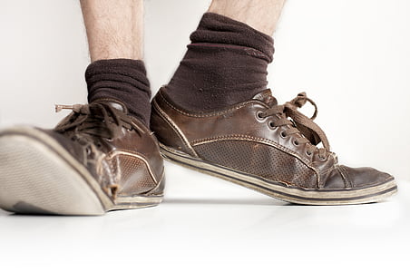 person wearing brown leather low-top shoes and brown socks thumbnail