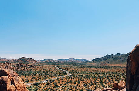 aerial photography of road between desert during daytime thumbnail