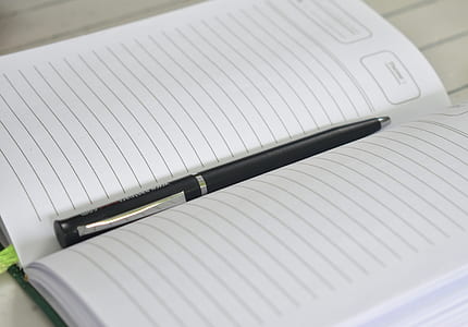 black click pen on white rulednotebook thumbnail