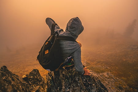 person standing on rock formation with fog weather thumbnail