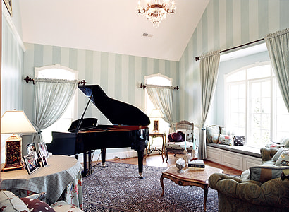 black grand piano near brown wooden center table thumbnail