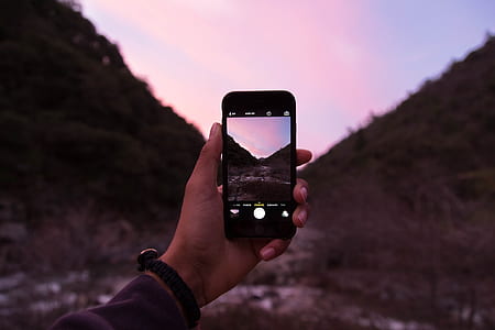person showing mountain range under clear blue sky thumbnail