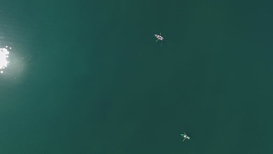 two boats sailing at sea during daytime thumbnail