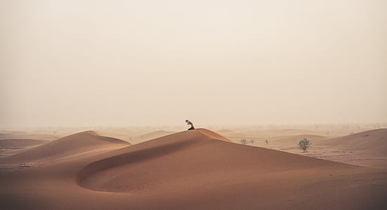 person standing on hill dessert thumbnail