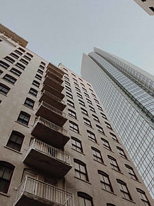 worm view photography of gray high-rise building thumbnail