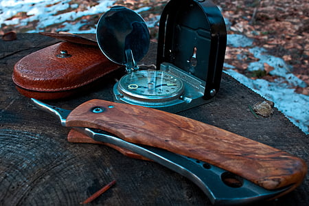 brown pocket knife beside of silver pocket watch thumbnail