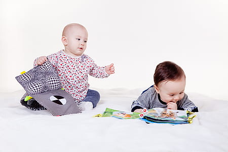 two children playing on floor thumbnail
