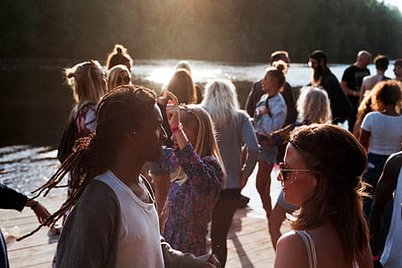 people dancing near river and tall trees at daytime thumbnail