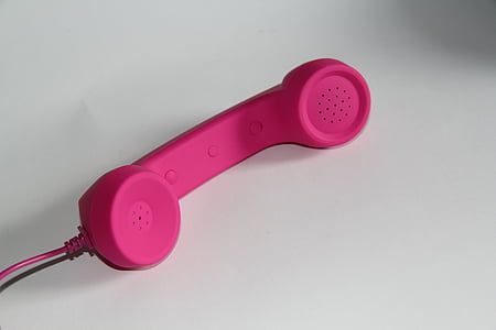 pink telephone handle on white surface thumbnail