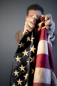 person holding USA flag thumbnail