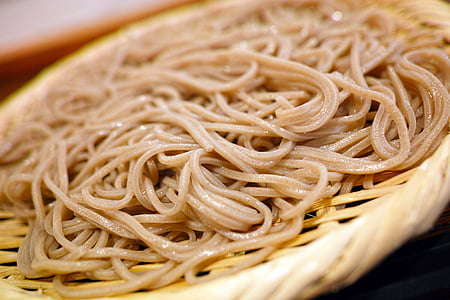 cooked noodles on white wicker plate thumbnail