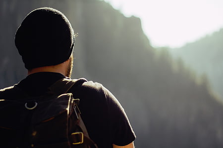 man wearing backpack and beanie selective potography thumbnail