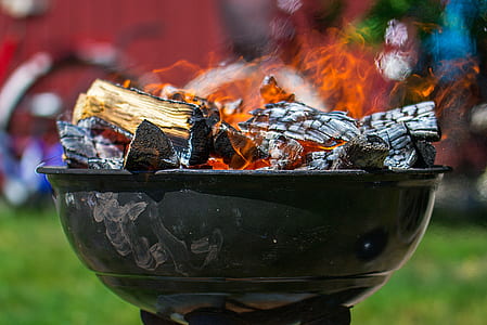 black fire pit with burning woods thumbnail