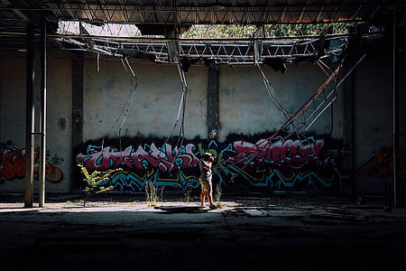 person standing in front of graffiti art thumbnail