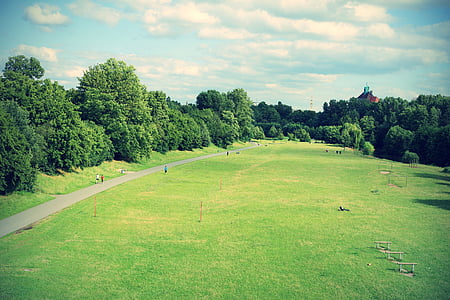 green grass field under cloudy sky thumbnail